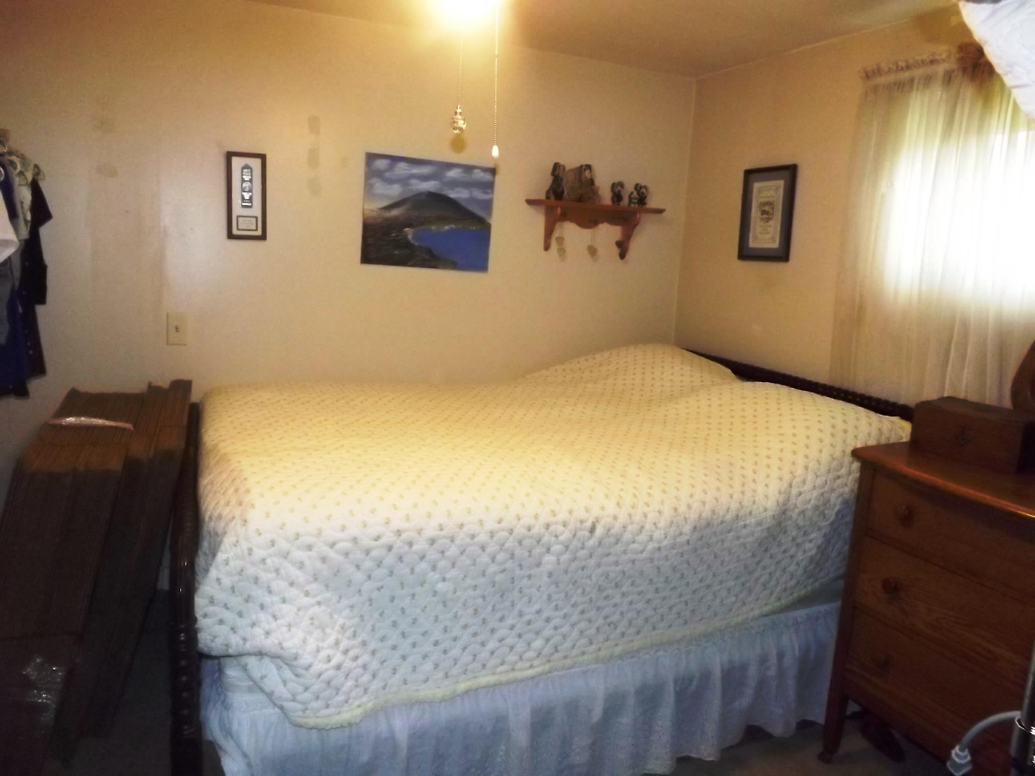 540 Parker Road Manchester, TN 37355 - Photo 26 of 30 a bedroom with a bed and wooden floor