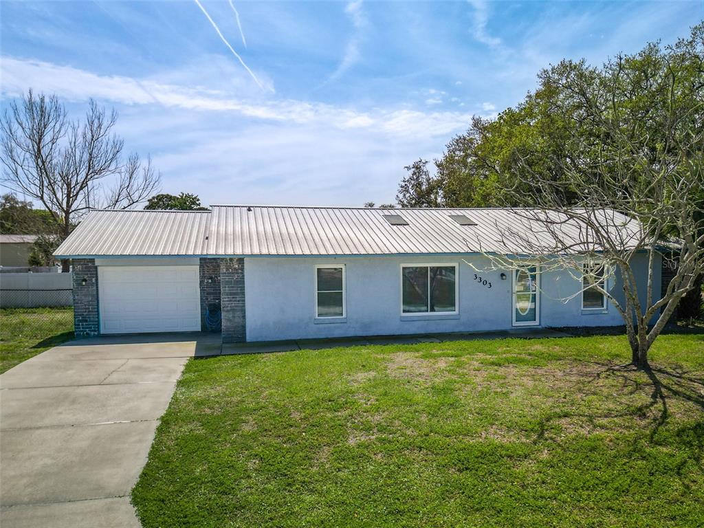 3303 Orange Tree Drive Edgewater, FL 32141 - Photo 1 of 33 a view of a house with a yard and large tree