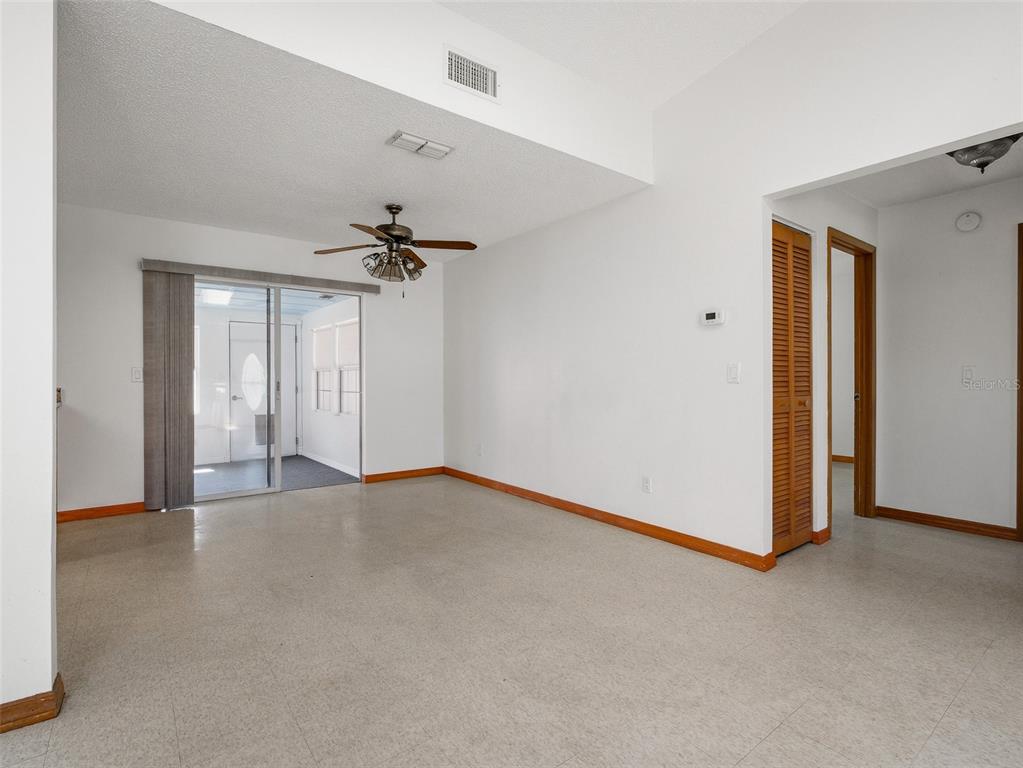 3303 Orange Tree Drive Edgewater, FL 32141 - Photo 15 of 33 a view of a livingroom with a ceiling fan and window