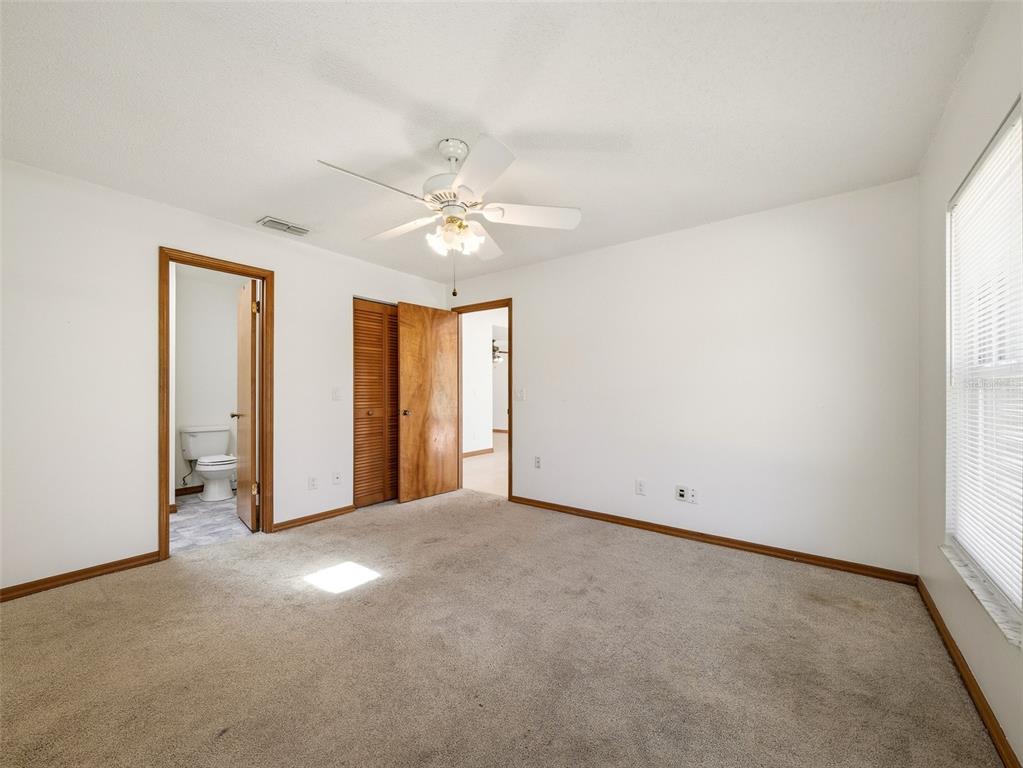 3303 Orange Tree Drive Edgewater, FL 32141 - Photo 16 of 33 an empty room with windows and fan
