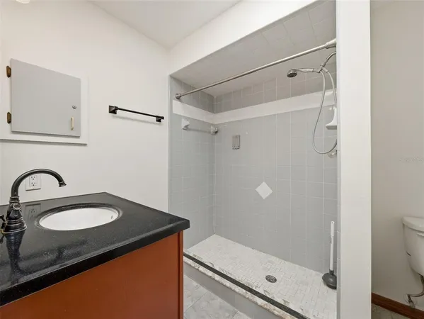 a view of a room with a window and a ceiling fan