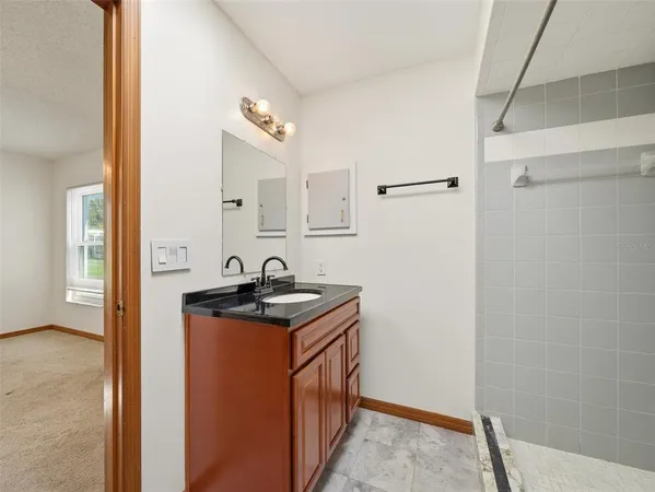 an empty room with closet and windows