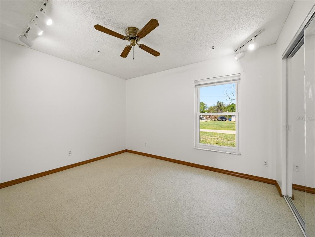 3303 Orange Tree Drive Edgewater, FL 32141 - Photo 21 of 33 a view of a room with a window and a ceiling fan