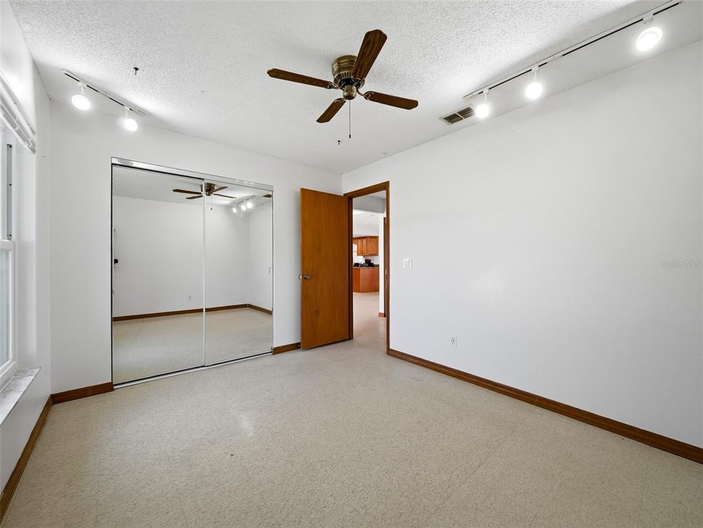 3303 Orange Tree Drive Edgewater, FL 32141 - Photo 22 of 33 an empty room with closet and windows