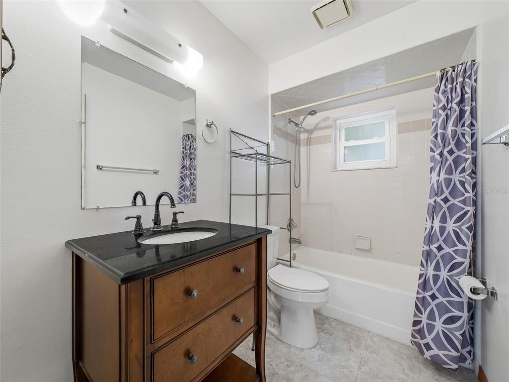 3303 Orange Tree Drive Edgewater, FL 32141 - Photo 23 of 33 a bathroom with a granite countertop sink a toilet and shower