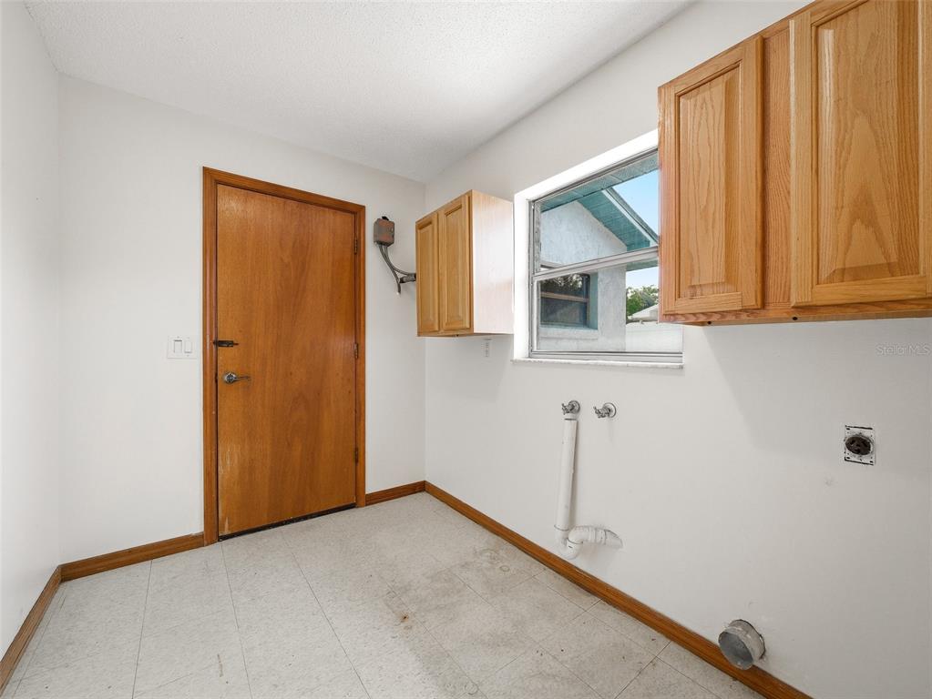 3303 Orange Tree Drive Edgewater, FL 32141 - Photo 26 of 33 a view of a room with a sink and cabinets