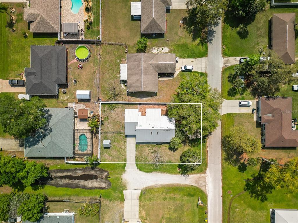 3303 Orange Tree Drive Edgewater, FL 32141 - Photo 32 of 33 an aerial view of residential houses with outdoor space and swimming pool