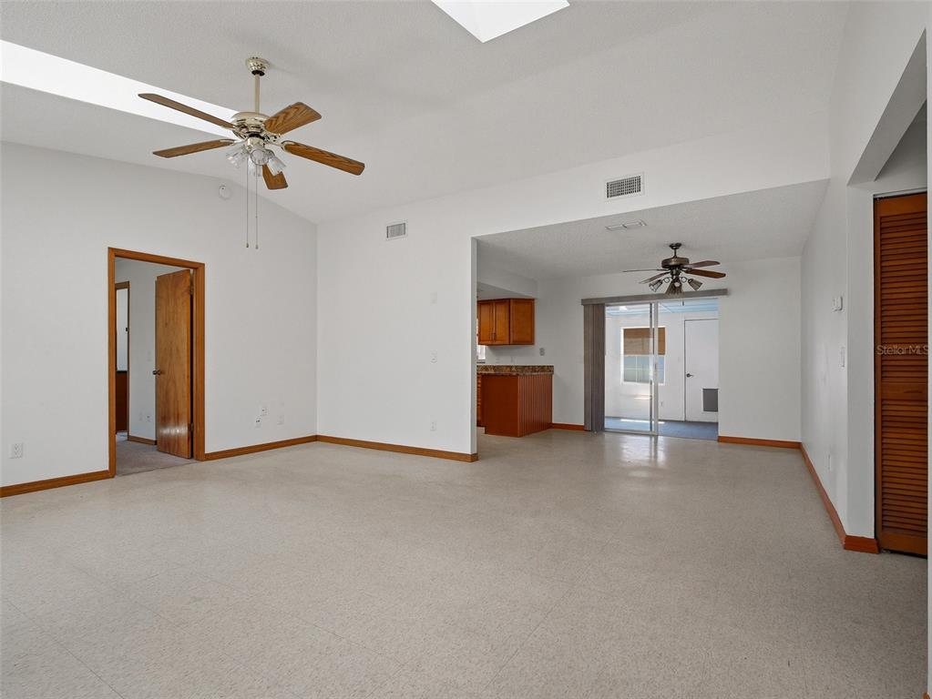 3303 Orange Tree Drive Edgewater, FL 32141 - Photo 4 of 33 a view of empty room with a ceiling fan and window