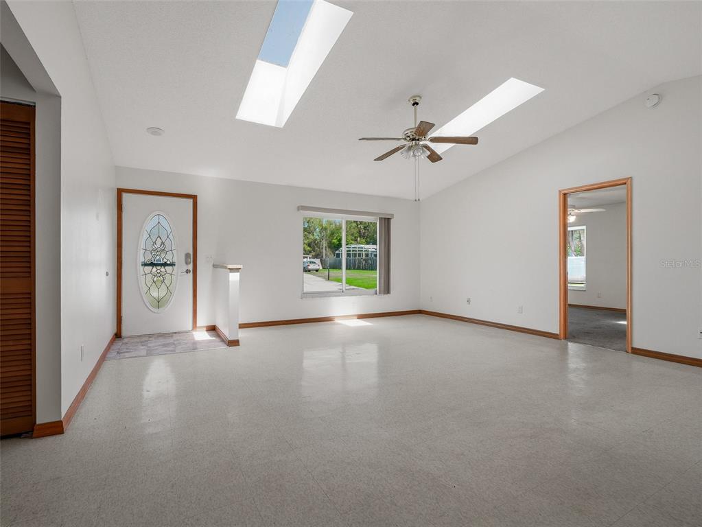 3303 Orange Tree Drive Edgewater, FL 32141 - Photo 7 of 33 an empty room with windows and fan
