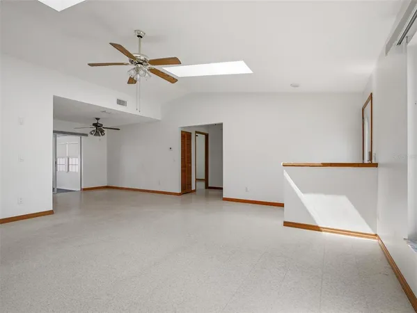 a kitchen with granite countertop a sink stove and refrigerator