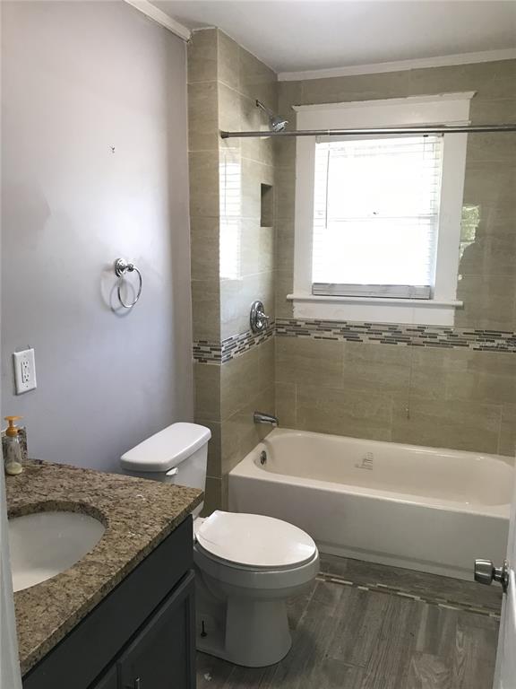 1952 Morrill Street, Unit B Sarasota, FL 34236 - Photo 8 of 12 a bathroom with a granite countertop toilet a sink and bathtub