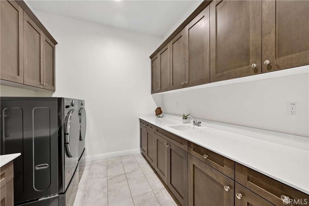 17549 Bretton Woods Place Riverside, CA 92504 - Photo 16 of 38 Laundry room with sink and folding space