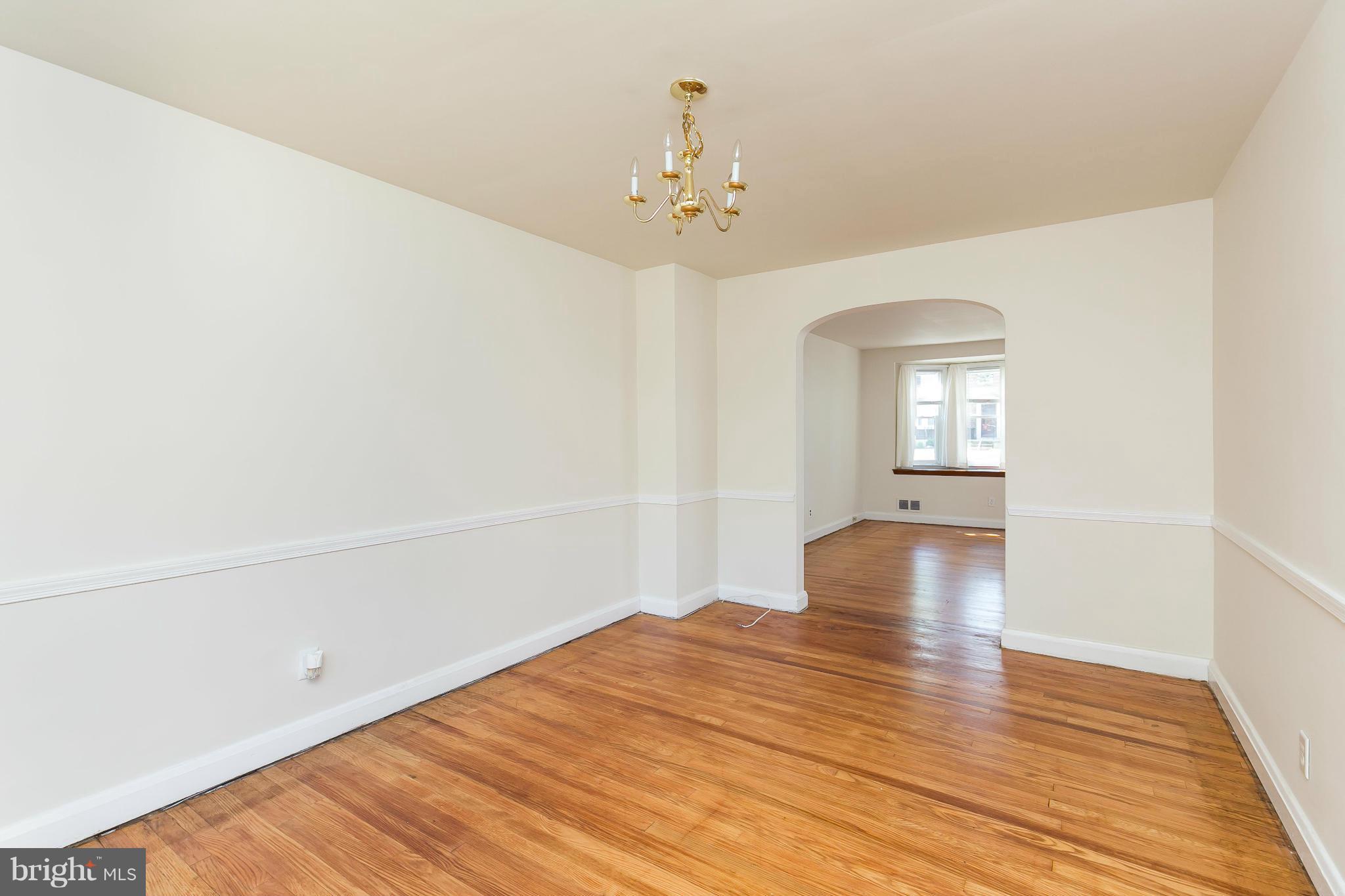 214 Stanmore Road Baltimore, MD 21212 - Photo 8 of 21 wooden floor in an empty room with a window