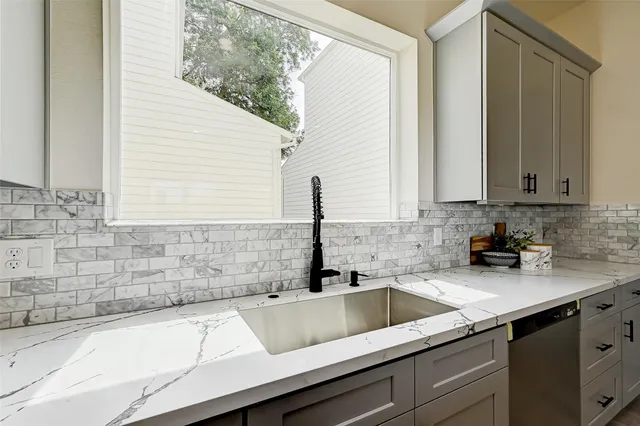 a kitchen with a sink and cabinets