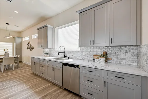 a kitchen with sink and cabinets
