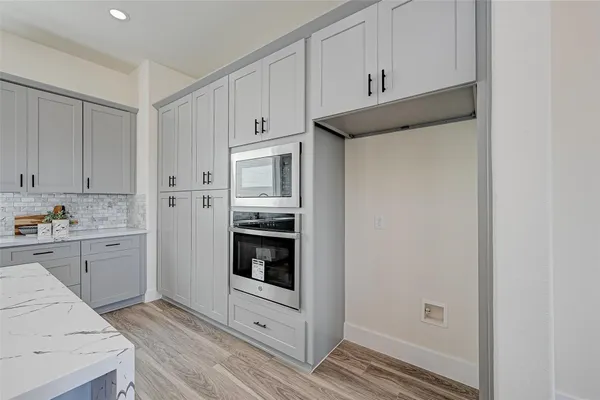 a kitchen with cabinets and stainless steel appliances
