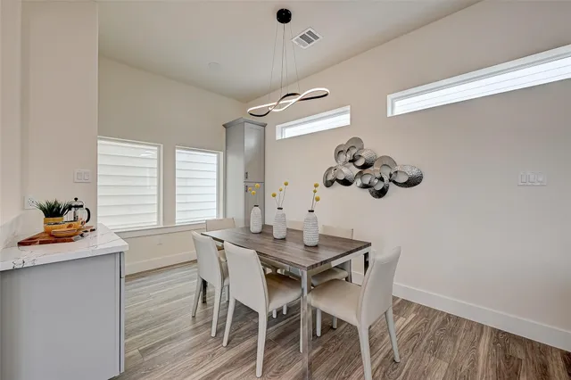 a dining room with furniture and window