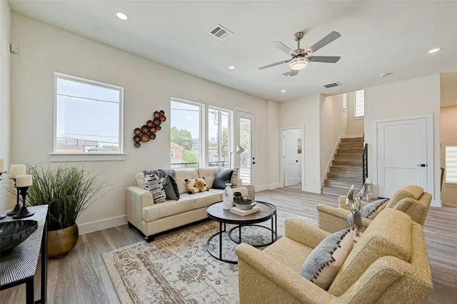 a living room with furniture and wooden floor