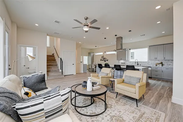 a living room with furniture and kitchen view