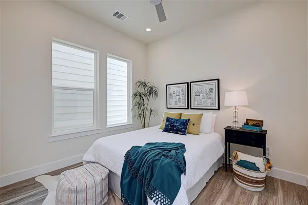 a bedroom with a bed and a chair