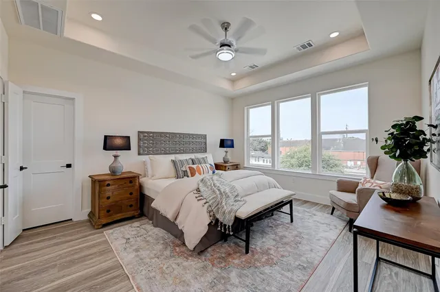 a living room with a bed furniture and a large window
