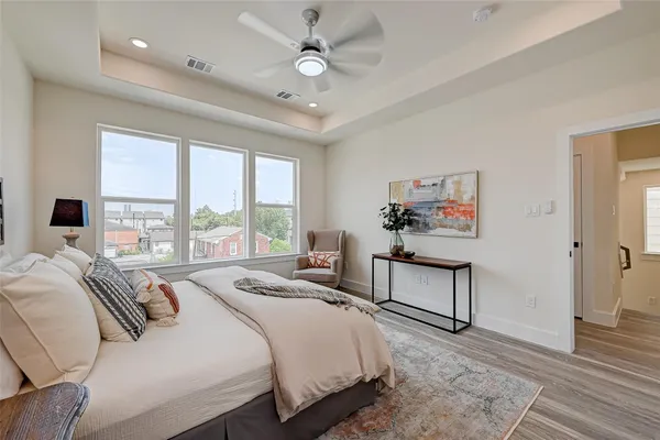 a spacious bedroom with a bed and a chandelier