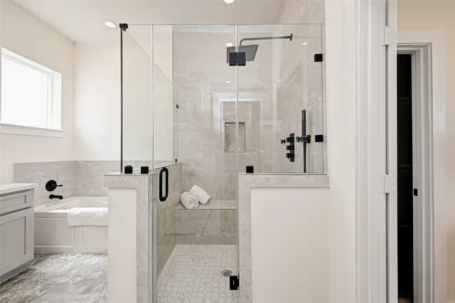 a bathroom with a tub sink and mirror