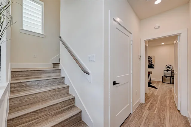 a view of a hallway view with wooden floor and staircase