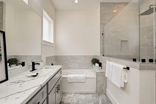 a bathroom with a sink a bathtub and a shower