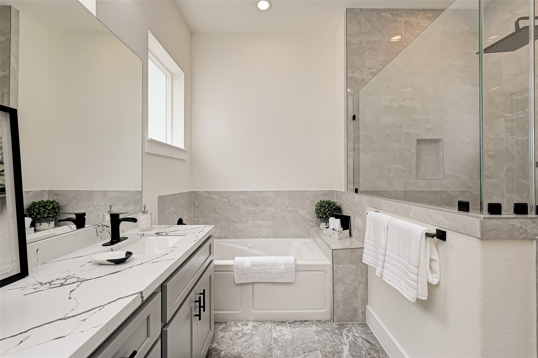 2905 Nagle Street Houston, TX 77004 - Photo 31 of 41 a bathroom with a sink a bathtub and a shower