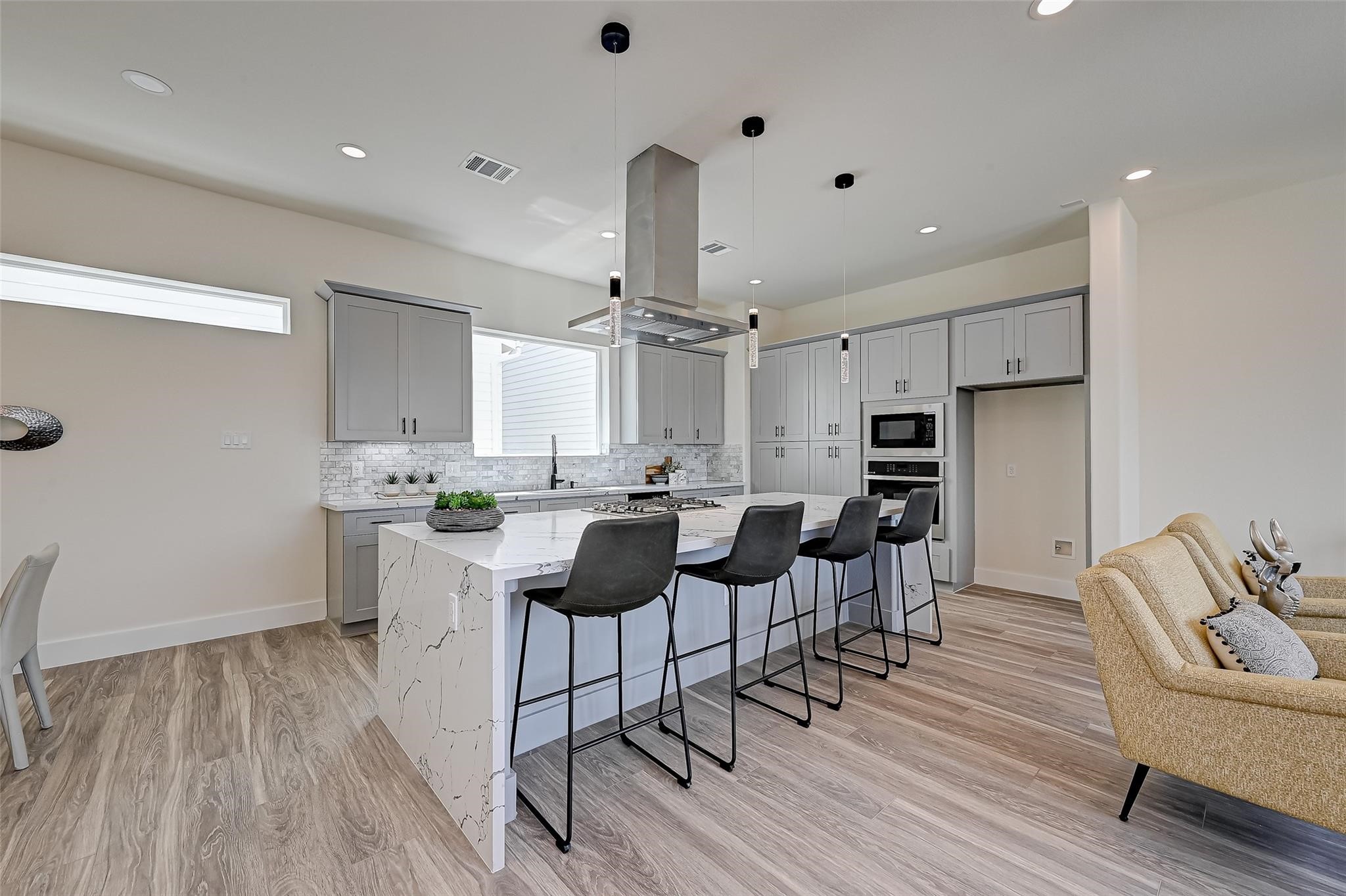2905 Nagle Street Houston, TX 77004 - Photo 7 of 41 a kitchen with stainless steel appliances kitchen island granite countertop a table chairs and a refrigerator