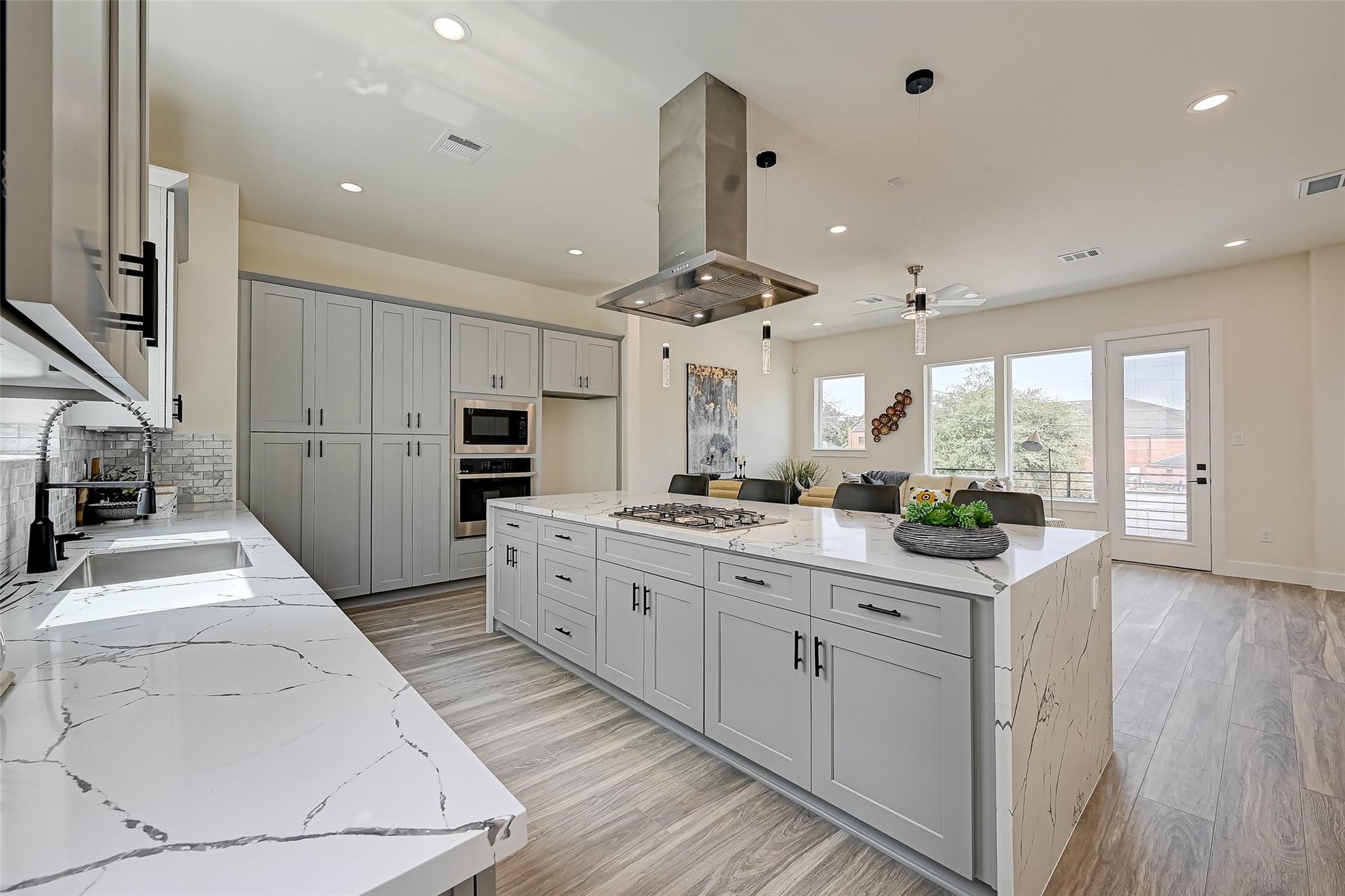 2905 Nagle Street Houston, TX 77004 - Photo 10 of 41 a kitchen with stainless steel appliances kitchen island granite countertop a lot of counter space and wooden floors