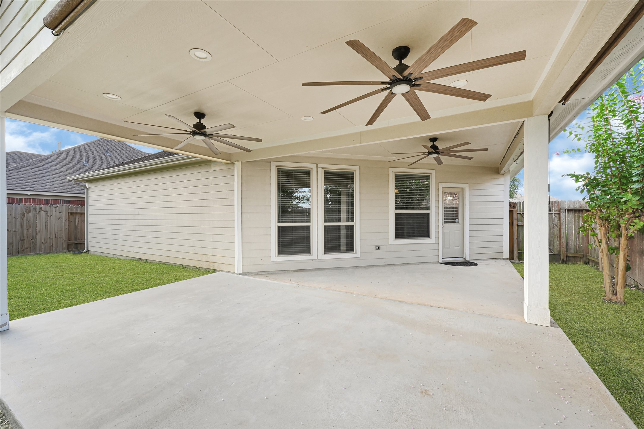 5331 Seabird Street Baytown, TX 77521 - Photo 36 of 38 a view of a porch with a table and a ceiling fan