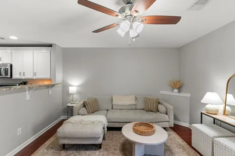 a living room with furniture and a chandelier