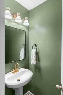 a bathroom with a sink and mirror