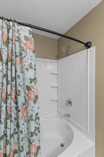 a bathroom with a bathtub and shower