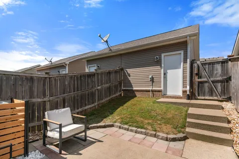 a view of a backyard with a chair and table