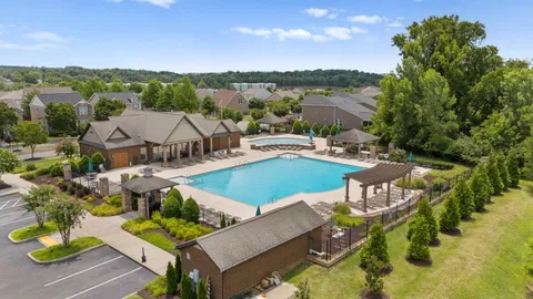 a view of a patio with furniture and a garden