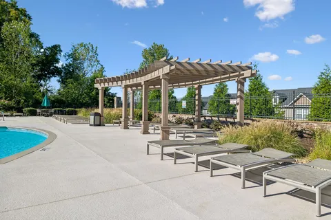 a view of a patio with swimming pool and sitting area