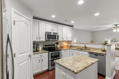 a kitchen with a sink stove and refrigerator