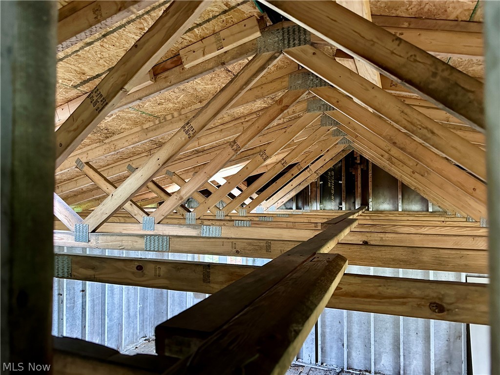5319 Fairtree Road Bedford Heights, OH 44146 - Photo 16 of 27 Exposed wood roof trusses with metal connector plates, oriented strand board (OSB) sheathing, and visible wood framing