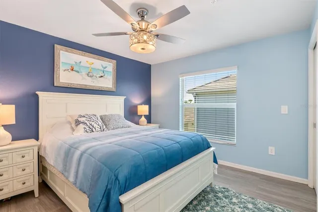 a bedroom with a bed chandelier and a window
