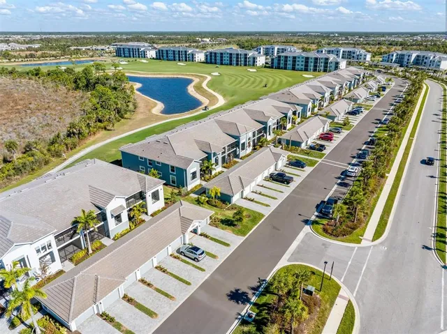 a view of a house with swimming pool and sitting area