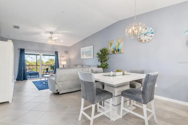 a view of a dining room with furniture and chandelier