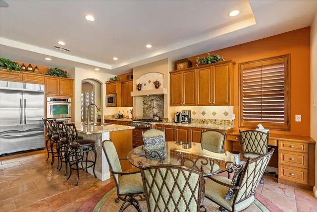 a large kitchen with a table and chairs