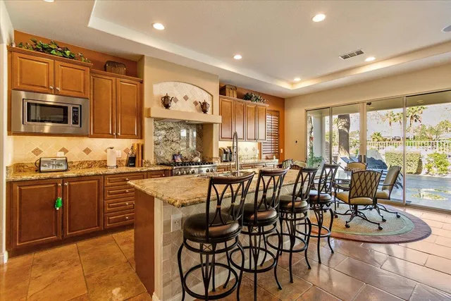 a kitchen with stainless steel appliances granite countertop a stove and cabinets