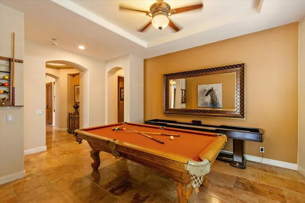 a room with pool table and windows