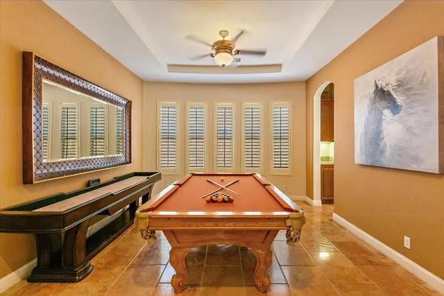 a living room with pool table and a window