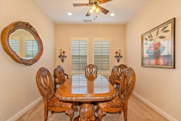 a view of a dining room with furniture and chandelier