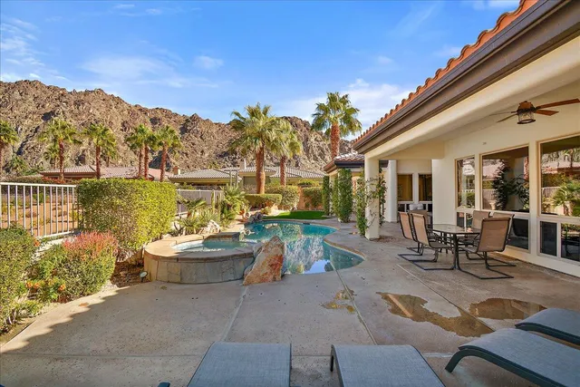a view of a patio with couches table and chairs and potted plants